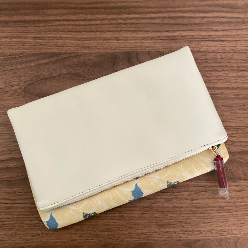 Reversible cream and yellow floral clutch bag with gold tone zippers